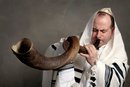 Blow the Trumpet in Zion - Man blowing shofar horn